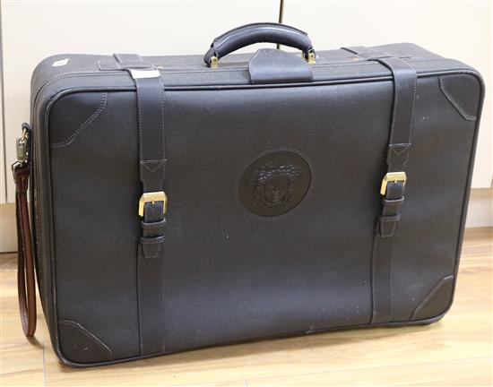 A Versace brown leather suitcase